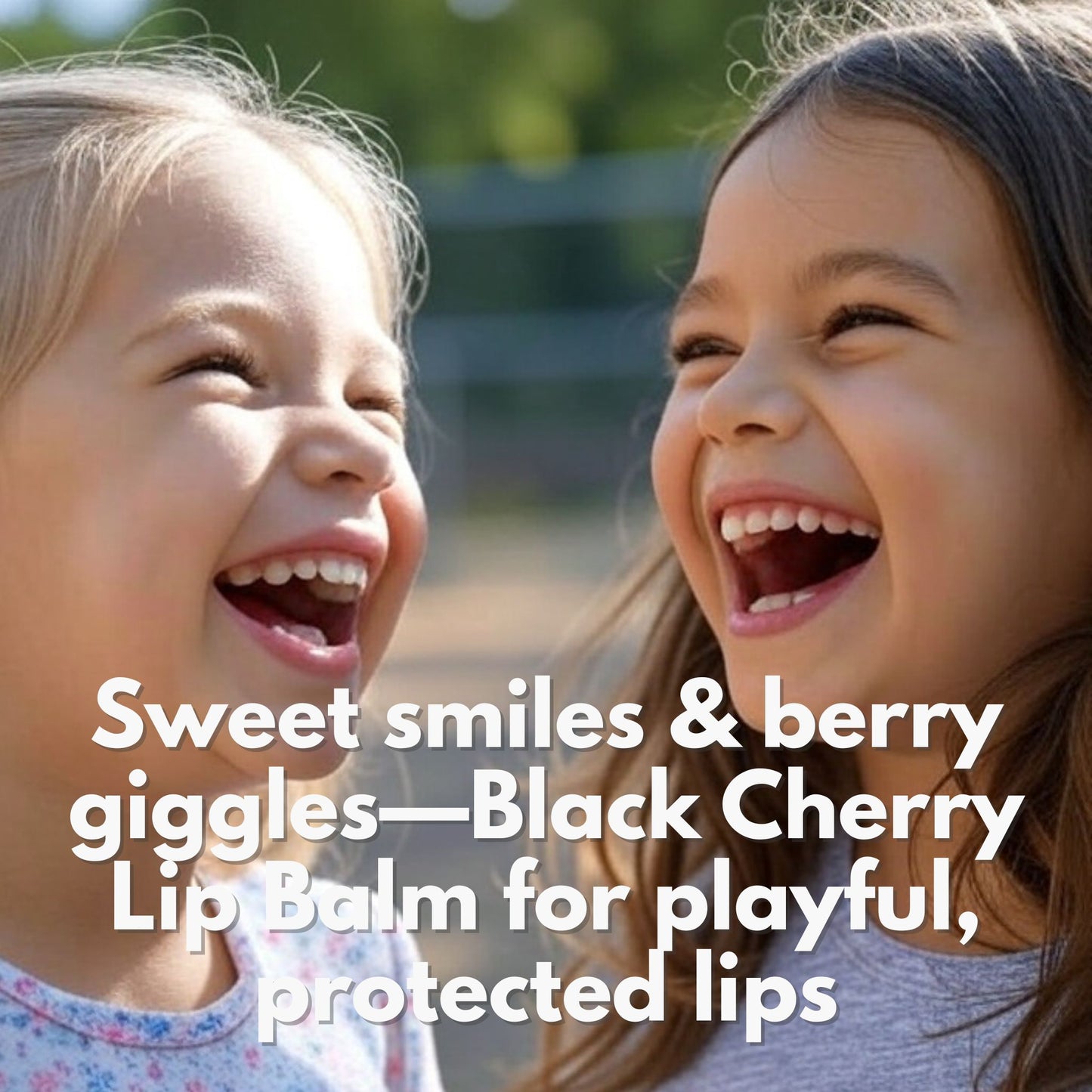 Two girls laughing in a park. with the caption: sweet smiles & berry giggles